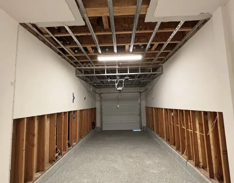 Garage walls cut along the bottom after a water heater leak