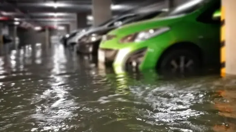 Storm runoff flooding a garage floor after heavy rain