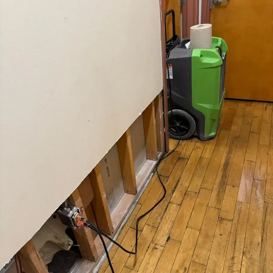 Drying equipment set up in a living room after flood water was removed